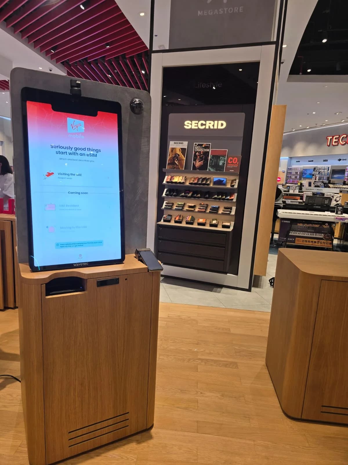 Self-service eSIM kiosk running the Virgin Mobile app in a retail store